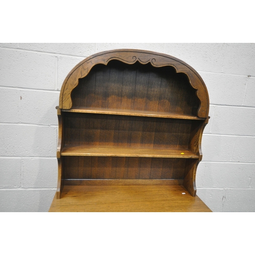 1294 - A 20TH CENTURY OAK DRESSER, the arched top with a two tier plate rack, atop a base with two drawers ... 