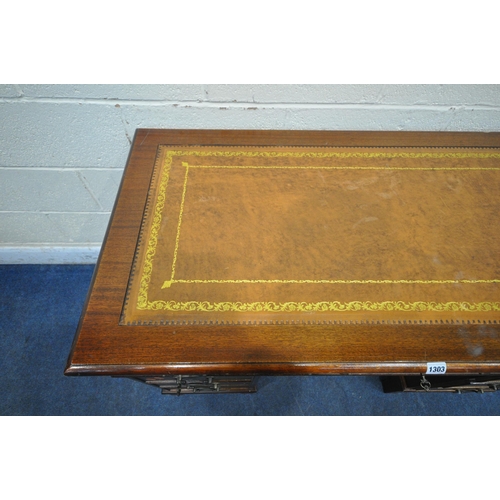 1303 - A 20TH CENTURY MAHOGANY TWIN PEDESTAL DESK, with a tanned leather writing surface, and an arrangemen... 