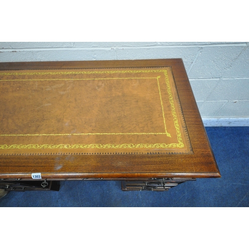 1303 - A 20TH CENTURY MAHOGANY TWIN PEDESTAL DESK, with a tanned leather writing surface, and an arrangemen... 