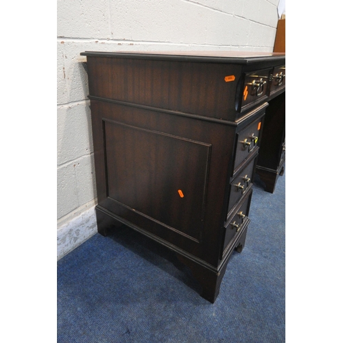 1304 - A 20TH CENTURY MAHOGANY TWIN PEDESTAL DESK, with an oxblood leather writing surface, and an arrangem... 