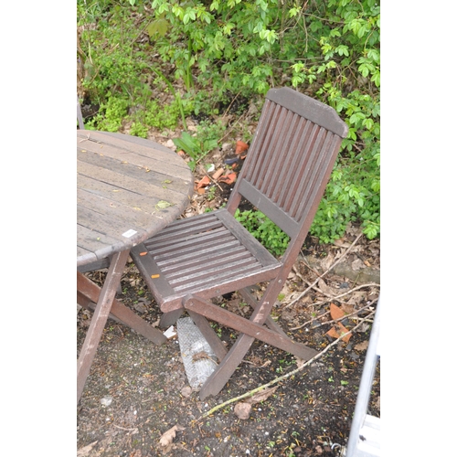 1004 - A WOODEN SLATTED FOLDING GARDEN TABLE 89cm in diameter and three folding chairs (condition report: o... 