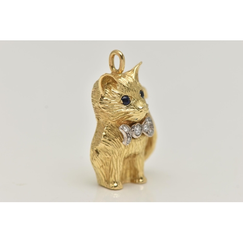 11 - AN 18CT GOLD DIAMOND AND SAPPHIRE CAT PENDANT, the seated cat with sapphire eyes and a bow set with ... 