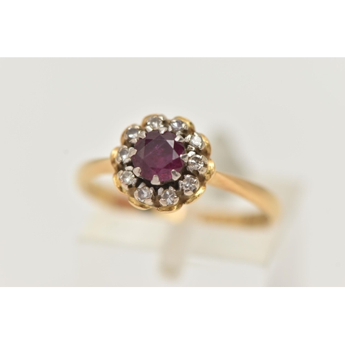 13 - AN 18CT GOLD RUBY AND DIAMOND CLUSTER RING, of a circular form, centrally set with a circular cut ru... 