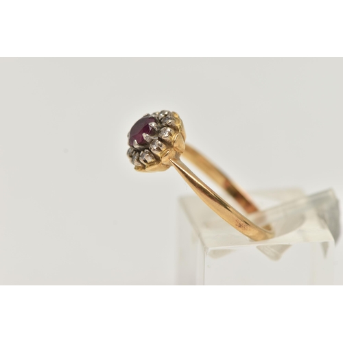 13 - AN 18CT GOLD RUBY AND DIAMOND CLUSTER RING, of a circular form, centrally set with a circular cut ru... 