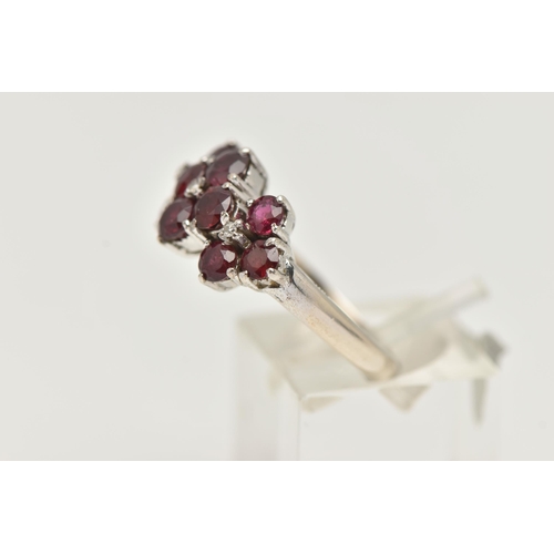 19 - A WHITE METAL RUBY AND DIAMOND DRESS RING, set with ten circular cut rubies, each claw set, with thr... 