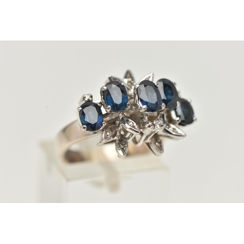 20 - A WHITE METAL SAPPHIRE AND DIAMOND DRESS RING, set with five oval cut blue sapphires, single cut dia... 