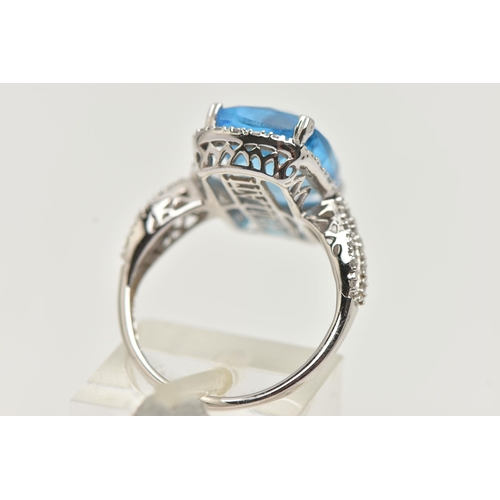 42 - A 'KALLATI' TOPAZ AND DIAMOND DRESS RING, a large rectangular cut blue topaz, approximate length 14m... 