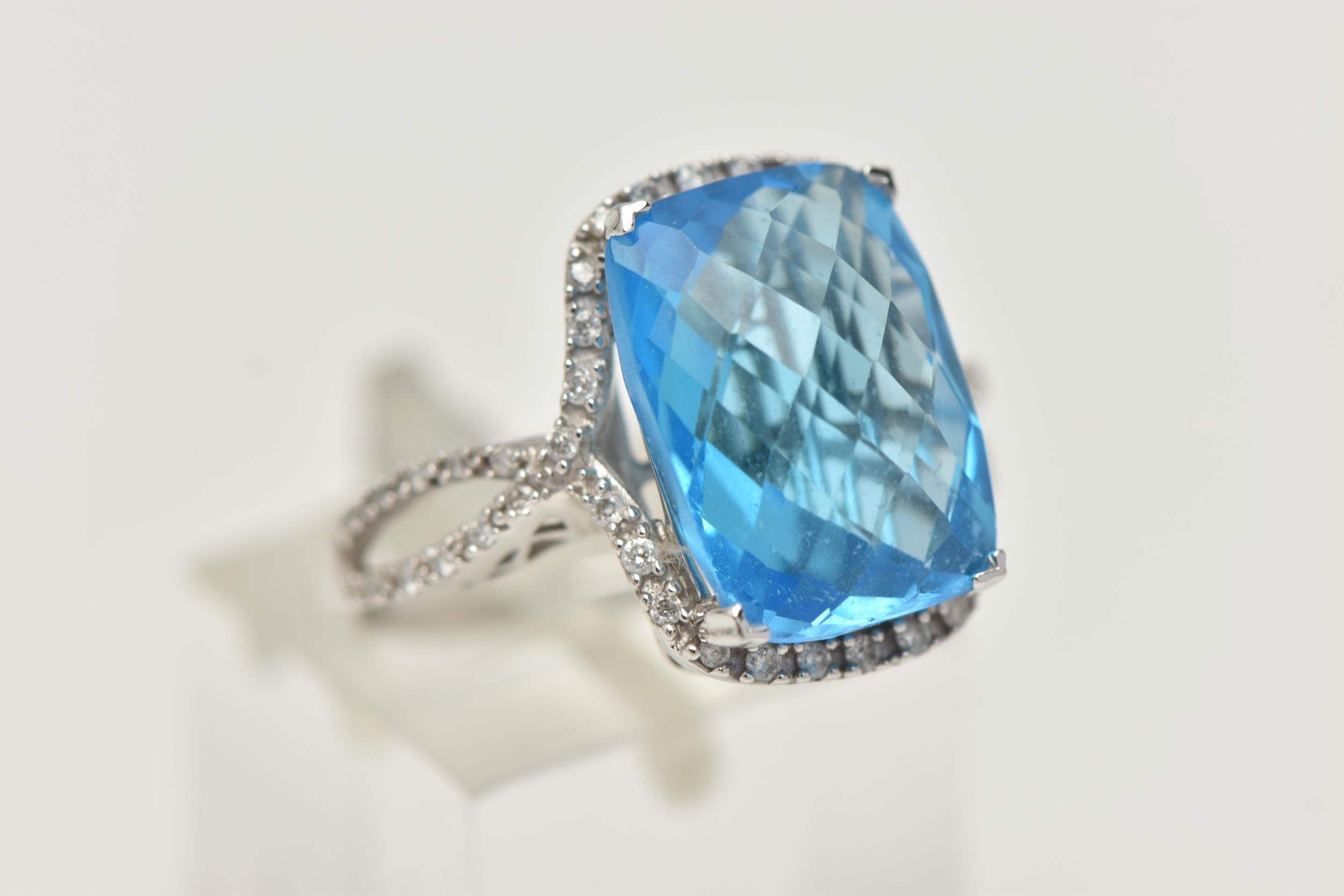 A 'KALLATI' TOPAZ AND DIAMOND DRESS RING, a large rectangular cut blue ...