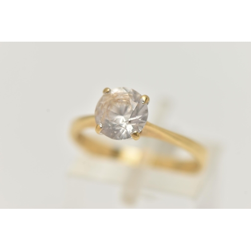 52 - A YELLOW METAL TOPAZ RING, set with a circular cut colourless topaz, in a four claw setting, pinched... 