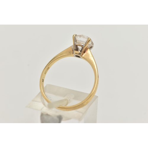 52 - A YELLOW METAL TOPAZ RING, set with a circular cut colourless topaz, in a four claw setting, pinched... 