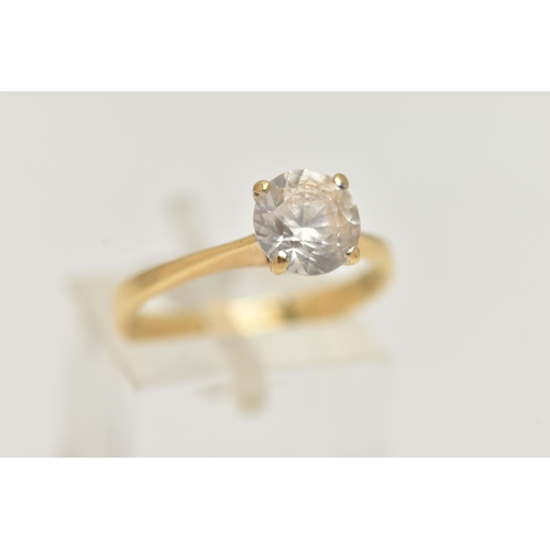 52 - A YELLOW METAL TOPAZ RING, set with a circular cut colourless topaz, in a four claw setting, pinched... 