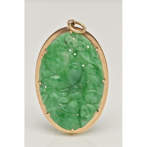 7 - A 9CT GOLD CARVED JADE PENDANT, the oval jade panel carved to depict flowers, foliage and possibly f... 