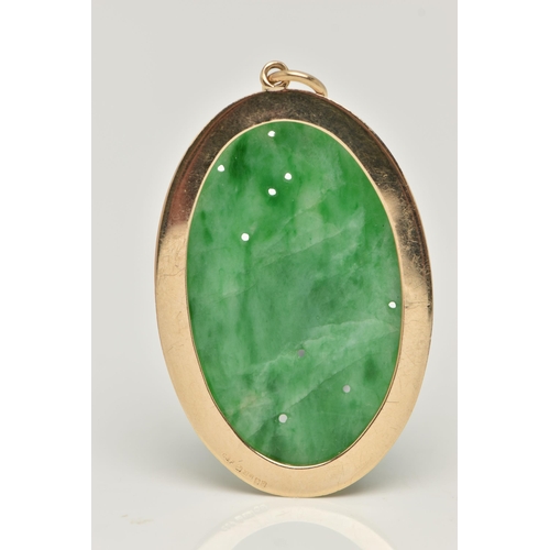 7 - A 9CT GOLD CARVED JADE PENDANT, the oval jade panel carved to depict flowers, foliage and possibly f... 