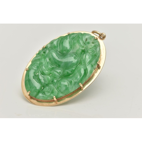 7 - A 9CT GOLD CARVED JADE PENDANT, the oval jade panel carved to depict flowers, foliage and possibly f... 