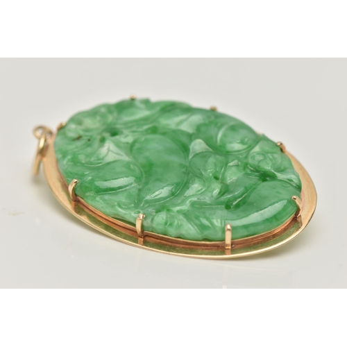 7 - A 9CT GOLD CARVED JADE PENDANT, the oval jade panel carved to depict flowers, foliage and possibly f... 