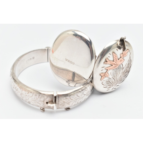 71 - A SILVER HINGED BANGLE AND LOCKET, the bangle with floral pattern, fitted with a push piece integrat... 