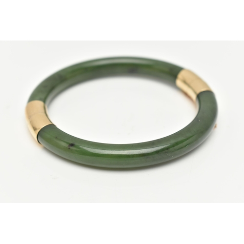 9 - A NEPHRITE JADE BANGLE, with fittings to the hinge and clasp, safety chain attached, clasp stamped 1... 