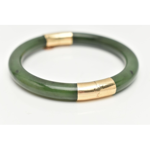 9 - A NEPHRITE JADE BANGLE, with fittings to the hinge and clasp, safety chain attached, clasp stamped 1... 