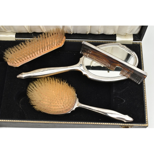 115 - A CASED FOUR PIECE SILVER VANITY SET, to include a hair brush, hand held mirror, clothes brush and a... 