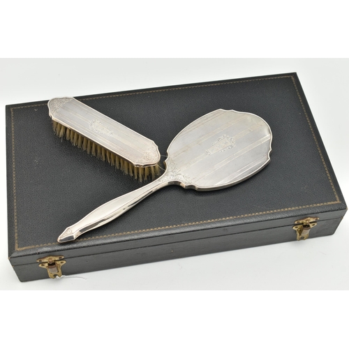 115 - A CASED FOUR PIECE SILVER VANITY SET, to include a hair brush, hand held mirror, clothes brush and a... 