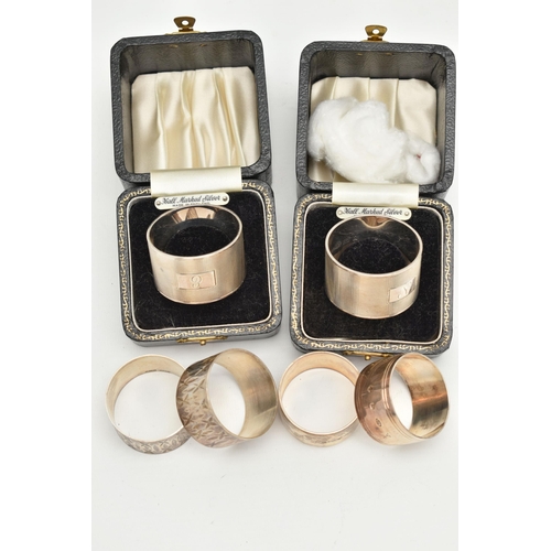 117 - THREE SETS OF SILVER NAPKIN RINGS, to include two boxed engine turned pattern rings, engraved initia... 