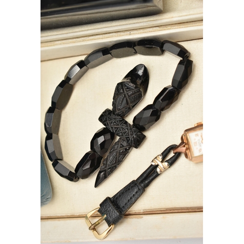 123 - FOUR ITEMS, to include an elasticated jet snake bracelet, designed as faceted jet beads to the carve... 