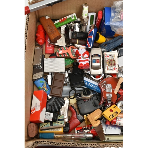 129 - A BOX OF ASSORTED ITEMS, to include various novelty lighters, in forms such as a phone, chocolate, s... 