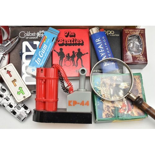 129 - A BOX OF ASSORTED ITEMS, to include various novelty lighters, in forms such as a phone, chocolate, s... 