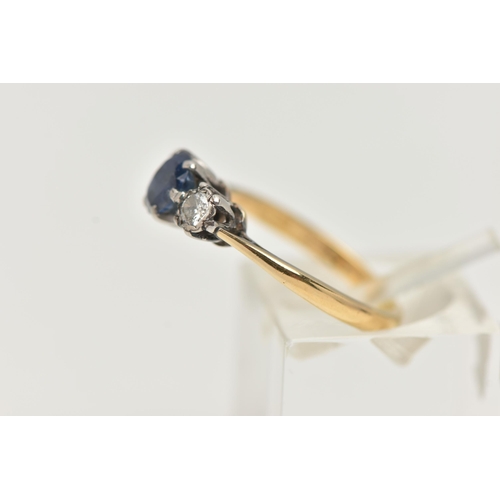 90 - A YELLOW METAL SAPPHIRE AND DIAMOND RING, centering on an oval cut, deep blue sapphire, flanked by i... 