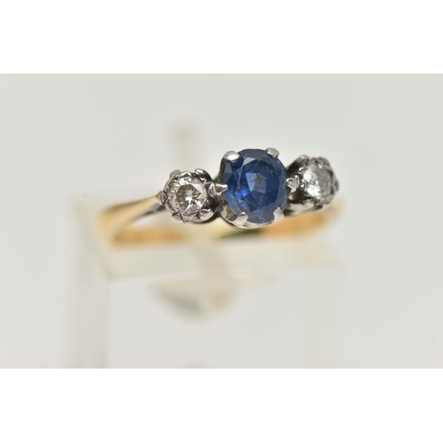 90 - A YELLOW METAL SAPPHIRE AND DIAMOND RING, centering on an oval cut, deep blue sapphire, flanked by i... 