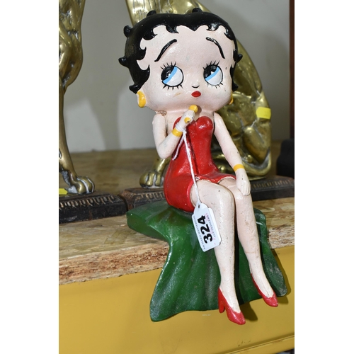 324 - A CAST IRON FIGURE OF BETTY BOOP AND A PAIR OF BRASS SPANIEL DOORSTOPS, the painted shelf sitting Be... 