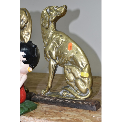 324 - A CAST IRON FIGURE OF BETTY BOOP AND A PAIR OF BRASS SPANIEL DOORSTOPS, the painted shelf sitting Be... 