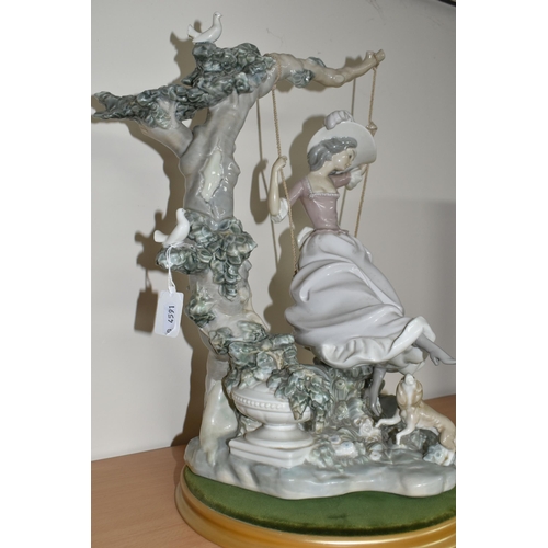 360 - A LLADRO 'SWINGING' SCULPTURE OF A GIRL ON A SWING, model no 1297, sculptor Salvador Debon, issued 1... 