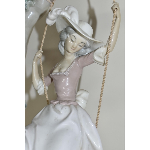 360 - A LLADRO 'SWINGING' SCULPTURE OF A GIRL ON A SWING, model no 1297, sculptor Salvador Debon, issued 1... 