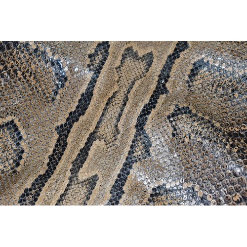 459 - A ROLLED SNAKE SKIN, possibly a python, length approximately 310cm in length and 50cm in width (Cond... 