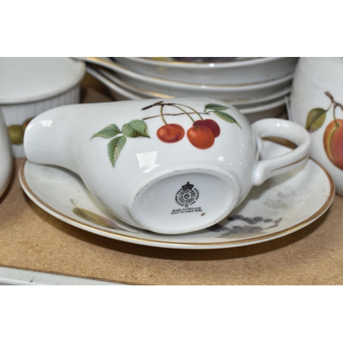 563 - A LARGE QUANTITY OF ROYAL WORCESTER EVESHAM DINING WARE, including serving dishes, plates, teapots, ... 