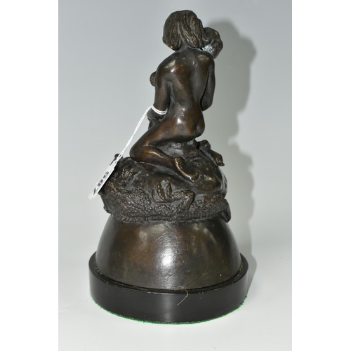 587 - A BRONZE FIGURE GROUP, depicting a mother and child kneeling on top of a mythical beast, loose on a ... 