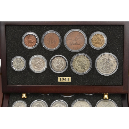 154 - A SMALL WOODEN COIN CABINET, consisting of eight drawers seven containing UK coinage from 1939-1945,... 