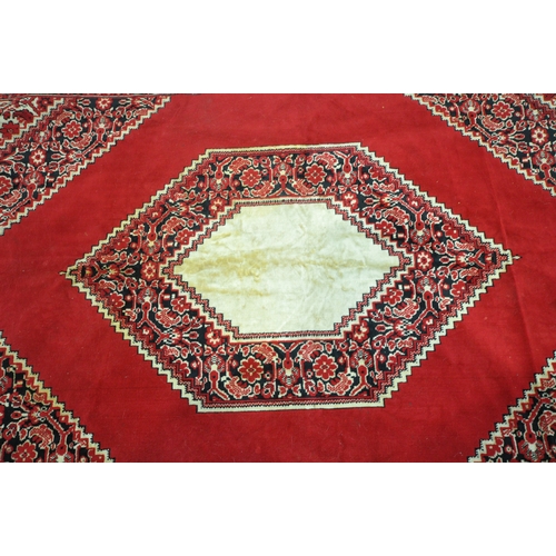 1199 - A RED GROUND SYNTHETIC SILK RUG, with central medallion, foliate designs and multi-strap border, 196... 