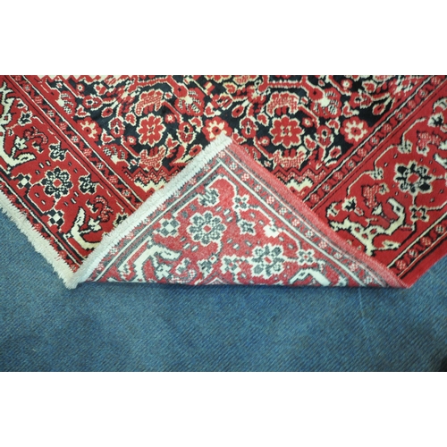 1199 - A RED GROUND SYNTHETIC SILK RUG, with central medallion, foliate designs and multi-strap border, 196... 