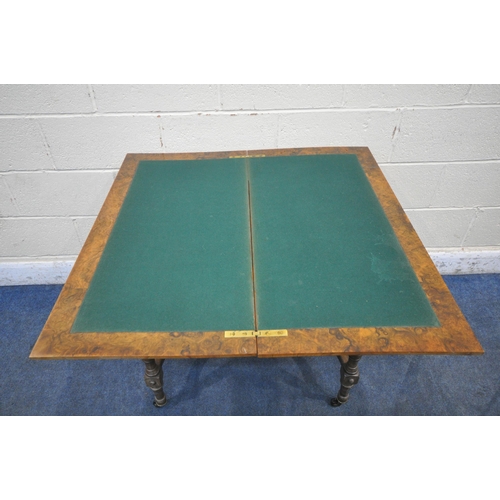 1203 - AN EDWARDIAN BURR WALNUT FOLD OVER CARD TABLE, the swivel top enclosing a green baize playing field ... 