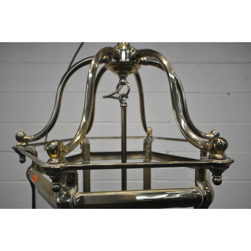 1206 - A 20TH CENTURY BRASS HEXAGONAL HALL LANTERN, the bevelled glass panes encasing a six branch light fi... 