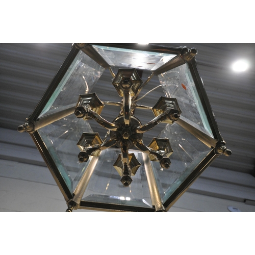 1206 - A 20TH CENTURY BRASS HEXAGONAL HALL LANTERN, the bevelled glass panes encasing a six branch light fi... 