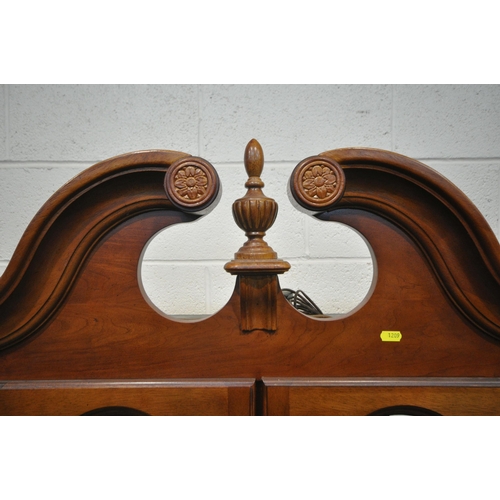 1209 - A LATE 20TH CENTURY HARDWOOD BOOKCASE, the twin swan neck pediment, flanking a finial, four glazed d... 