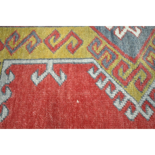 1211 - A TURKISH HAND WOVEN RUG, with repeating geometric patterns, 191cm x 100cm (condition report: genera... 