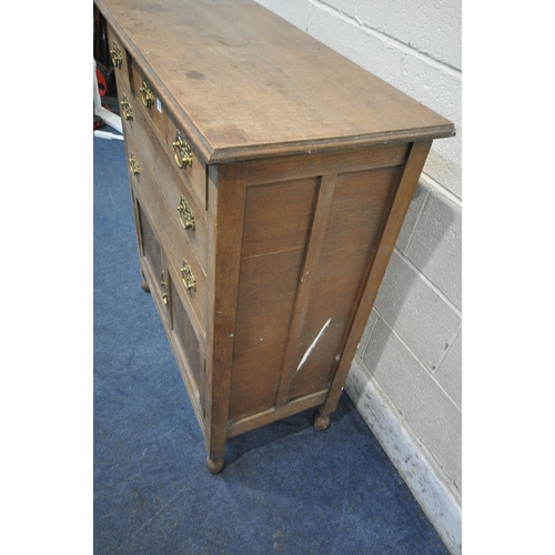 1217 - AN EARLY 20TH CENTURY OAK CABINET, fitted with five assorted drawers, above double cupboard doors, w... 