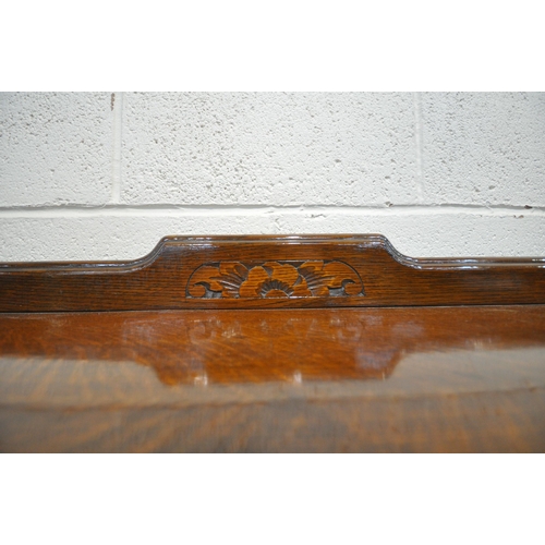 1222 - AN EARLY 20TH CENTURY OAK SIDEBOARD, with a raised back, fitted with three drawers, above double cup... 