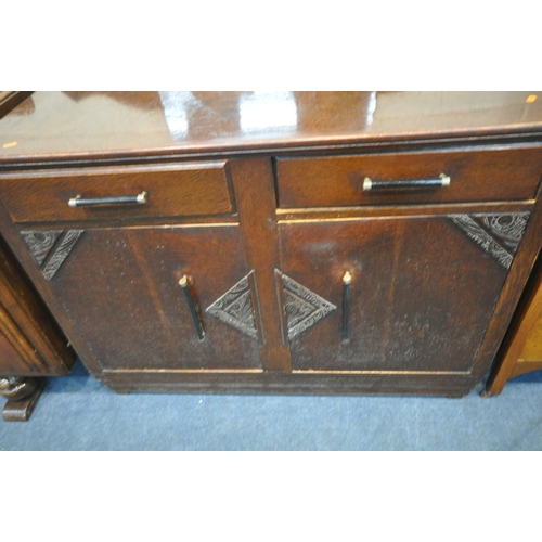 1222 - AN EARLY 20TH CENTURY OAK SIDEBOARD, with a raised back, fitted with three drawers, above double cup... 