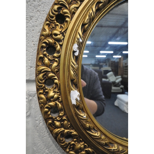 1225 - A GILT RESIN OVAL WALL MIRROR, with foliate design, 49cm x 65cm, a circular gilt resin convex wall m... 