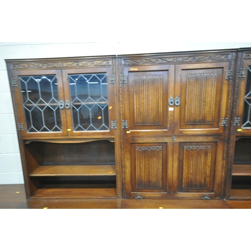 1231 - AN OLD CHARM WALL CABINET, each base fitted with two drawers, above double cupboard doors, two top s... 